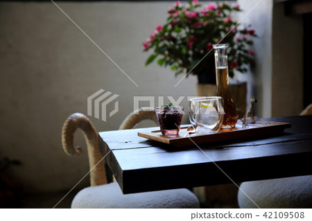 Berries tea with ice ball on wood background 42109508