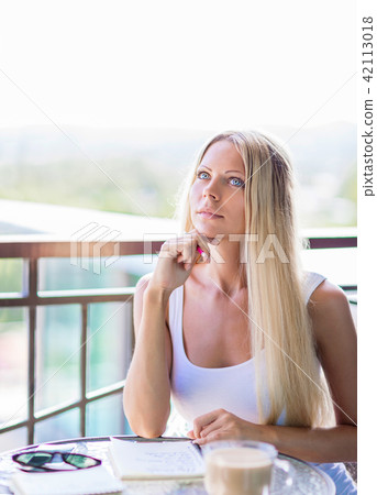 woman drink coffee and writing note book journal 42113018
