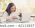 Asian women holding  credit card to payment  42113837