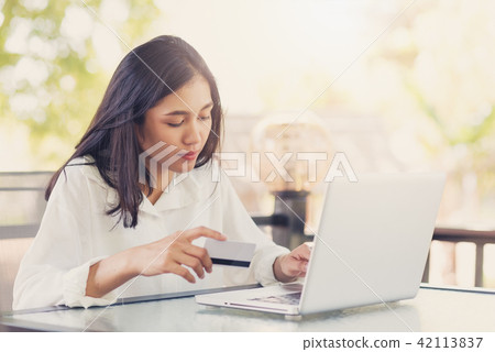 Asian women holding  credit card to payment  42113837