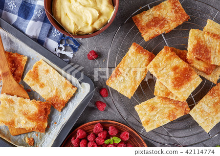 portions of puff pastry on a baking sheet 42114774
