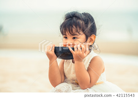 Adorable kid eating watermelon on the beach. Adorable kid eating watermelon on the beach. 42115543