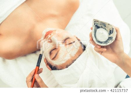 Beautiful woman having a facial treatment at spa. Beautiful woman having a facial treatment at spa. 42115737