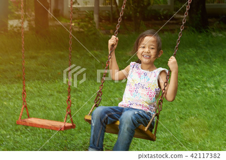 Little asian girl swing in park Little asian girl swing in park 42117382