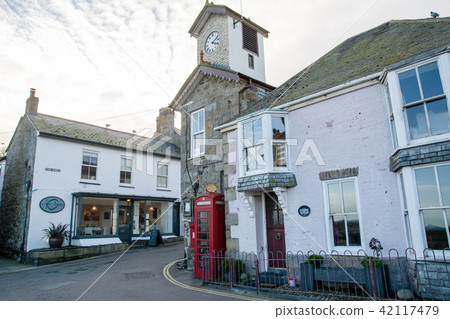 A narrow street with stone buildings In a country town in the western end of the UK 42117479