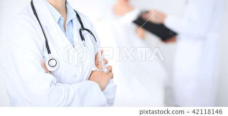 Unknown female doctor with medical staff  at hospital. Closeup of stethoscope 42118146