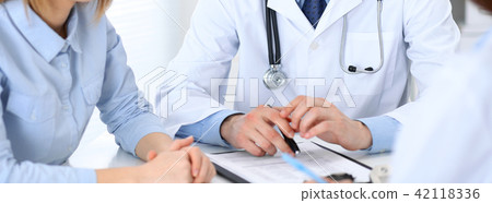 Doctors and patient talking while sitting at the table . Concept of support and trust in medicine Doctors and patient talking while sitting at the table . Concept of support and trust in medicine 42118336