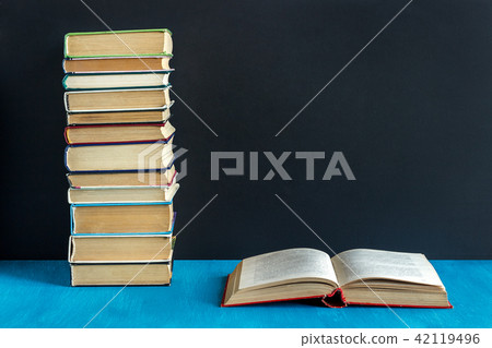Open book and stack of books Open book and stack of books 42119496