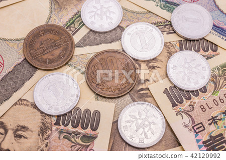Closeup of Japanese yen banknotes and Japanese yen Closeup of Japanese yen banknotes and Japanese yen 42120992