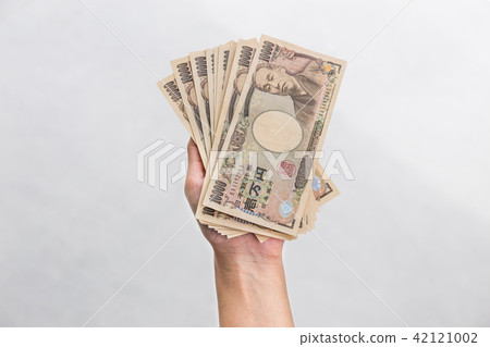 Businesswoman holding10,000 Japanese Yen money  42121002