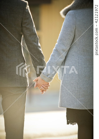 A man and woman holding hands A man and woman holding hands 42121972