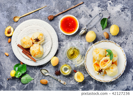 Dumplings with apricot and syrup Dumplings with apricot and syrup 42127236