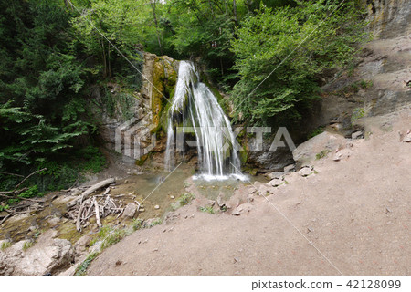 a small waterfall in a green coniferous forest. pl a small waterfall in a green coniferous forest. pl 42128099