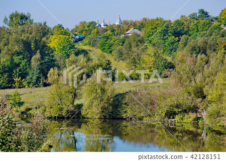 the domes of the village church rise above the gre 42128151