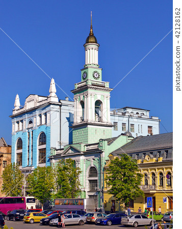 a blue church in a city with a high golden spire a 42128162