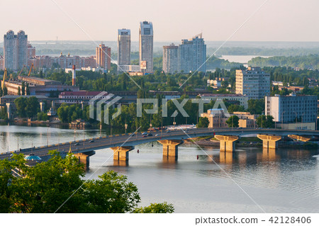 A large bridge over a wide river and an urban land 42128406