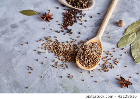 Coriander in wooden spoon with clipping path on white textured background, close-up, selective focus 42129610