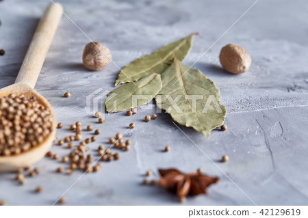 Coriander in wooden spoon with clipping path on white textured background, close-up, selective focus 42129619