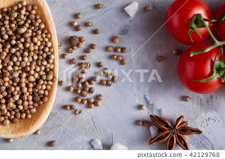 Coriander in wooden spoon with clipping path on white textured background, close-up, selective focus 42129768