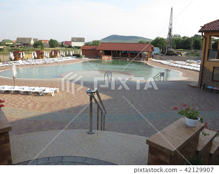 resort with a swimming pool, white sun loungers an resort with a swimming pool, white sun loungers an 42129907