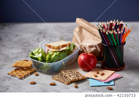 School or picnic lunch box with sandwich and various colorful vegetables and fruits on wooden School or picnic lunch box with sandwich and various colorful vegetables and fruits on wooden 42130713