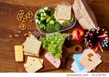 Concept of school lunch break with healthy lunch box and school supplies on wooden desk, selective 42130797