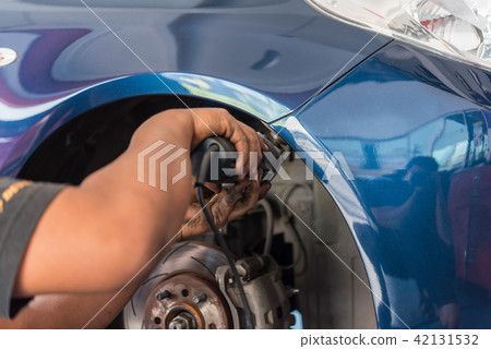 Checking car fiber bumper body part at car garage Checking car fiber bumper body part at car garage 42131532