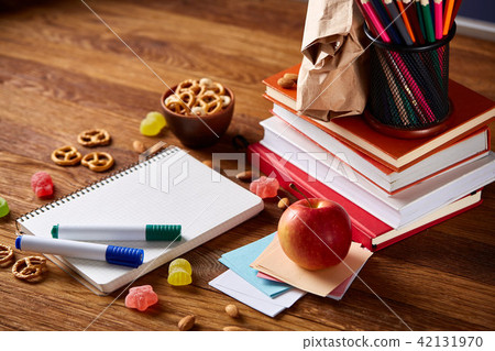 A notebook, two markers and banana on a wooden table, copy space for text, selective focus. A notebook, two markers and banana on a wooden table, copy space for text, selective focus. 42131970