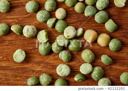Green peas on rustic wooden background, close-up, top view, selective focus. Green peas on rustic wooden background, close-up, top view, selective focus. 42132201