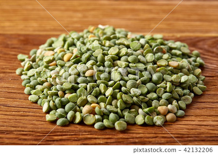 Pile of green peas on rustic wooden background, close-up, top view, selective focus. 42132206