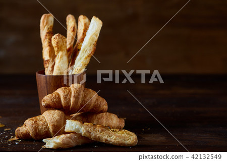 Puff pastries on dark wooden table, close-up, selective focus, backlight. Puff pastries on dark wooden table, close-up, selective focus, backlight. 42132549