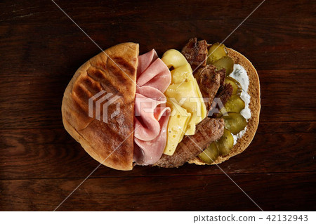 Pita stuffed with meat, cheese and sauce on wooden background, top view, selective focus. 42132943