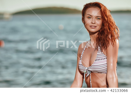 Pretty slim girl at sea beach 42133066