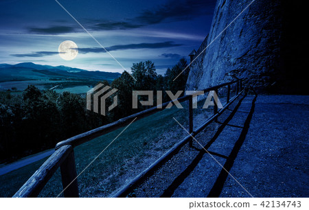 castle wall and railing on a hill at night castle wall and railing on a hill at night 42134743
