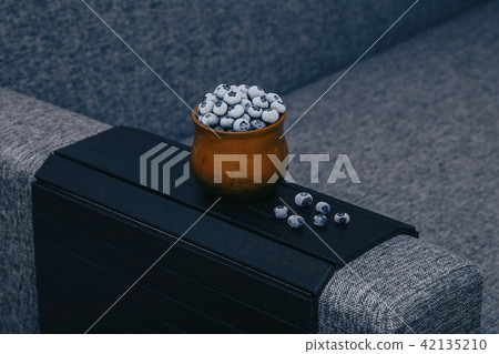 frozen blueberries in a clay cup on a wooden board table frozen blueberries in a clay cup on a wooden board table 42135210