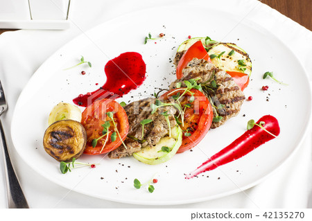 Grilled meat with vegetables, zucchini, mushrooms Grilled meat with vegetables, zucchini, mushrooms 42135270