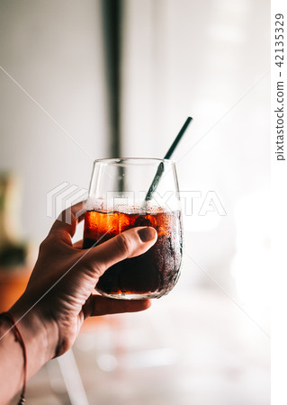 Woman's hand holding cold brew coffee 42135329