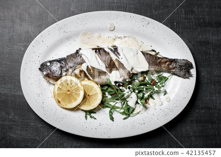 Roasted seabass with rosemary and herbs Roasted seabass with rosemary and herbs 42135457