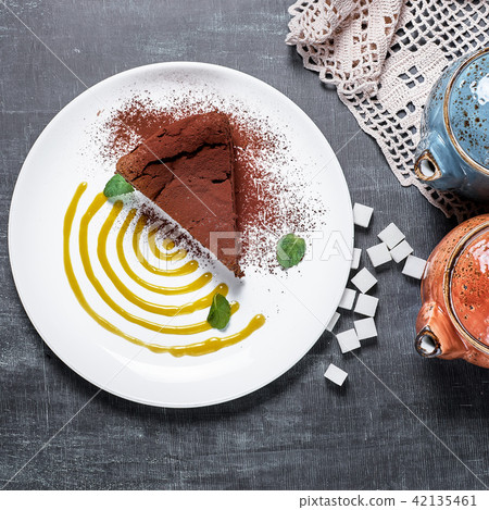 piece of chocolate cake with mint leaves, top view 42135461