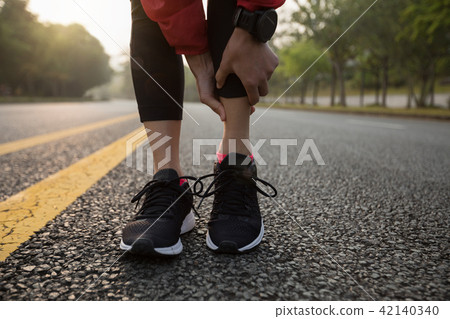 female runner touching sport injured calf female runner touching sport injured calf 42140340