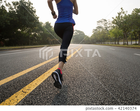 Fitness sportswoman running on sunrise trail Fitness sportswoman running on sunrise trail 42140374