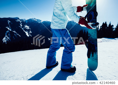 snowboarder with snowboard on ski slope snowboarder with snowboard on ski slope 42140460