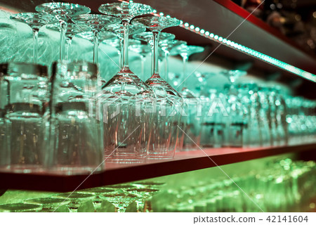 Crystal glass, row and Stack of different glass shelf behind the bar counter, and ready to use Crystal glass, row and Stack of different glass shelf behind the bar counter, and ready to use 42141604