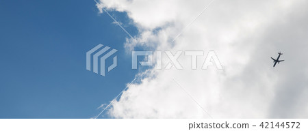 Passenger plane flying in the blue sky 42144572