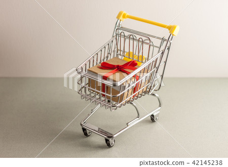 mini shopping cart with boxes with presents 42145238