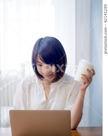 young woman using laptop young woman using laptop 42145289