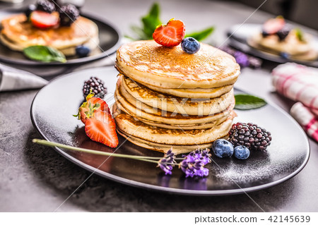Pancakes with strawberries blackberries blueberrie 42145639