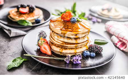 Pancakes with strawberries blackberries blueberrie 42145640