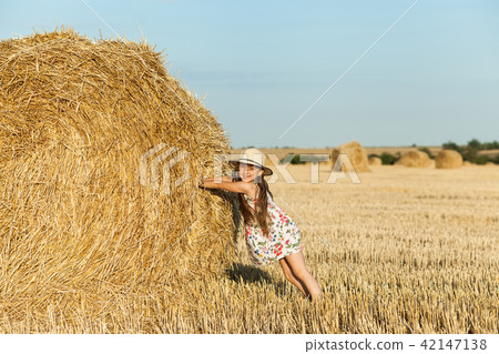 Happy girl on field of wheat with bread Happy girl on field of wheat with bread 42147138