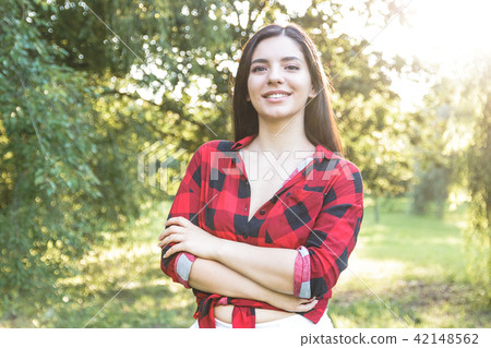 Smiling beautiful brunette girl in a red shirt 42148562